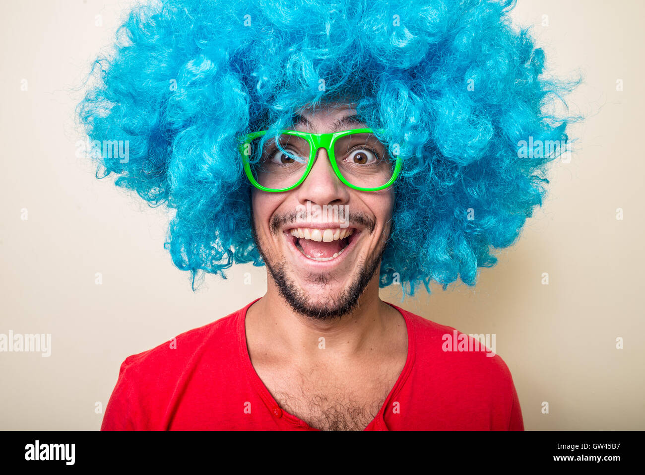 crazy funny young man with blue wig Stock Photo Alamy