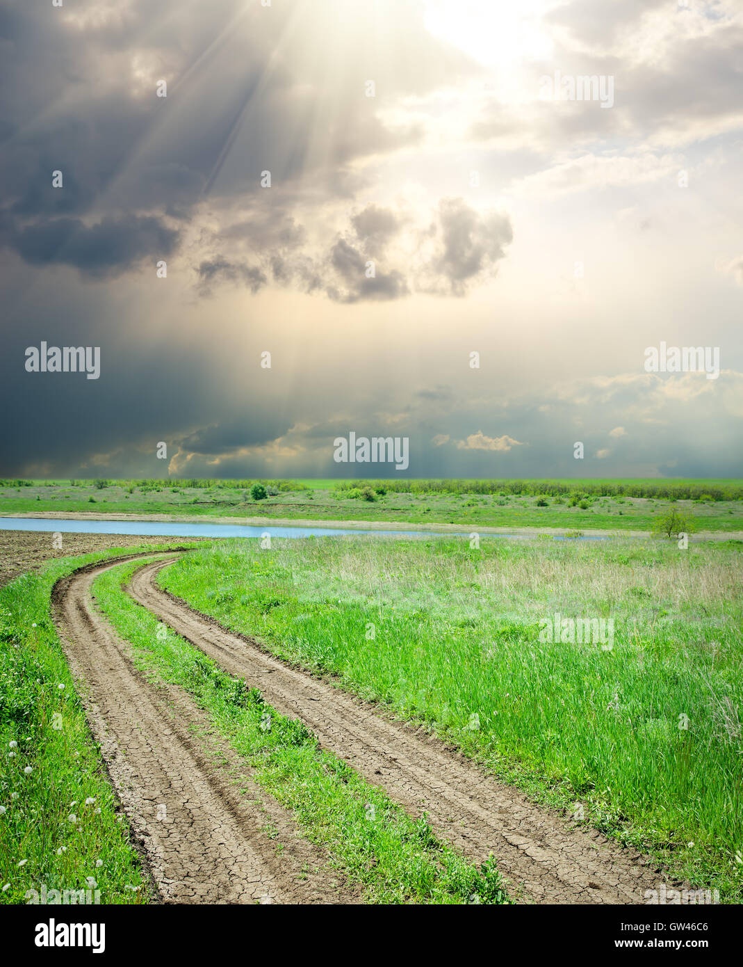 rural road in green grass under dramatic sky Stock Photo - Alamy