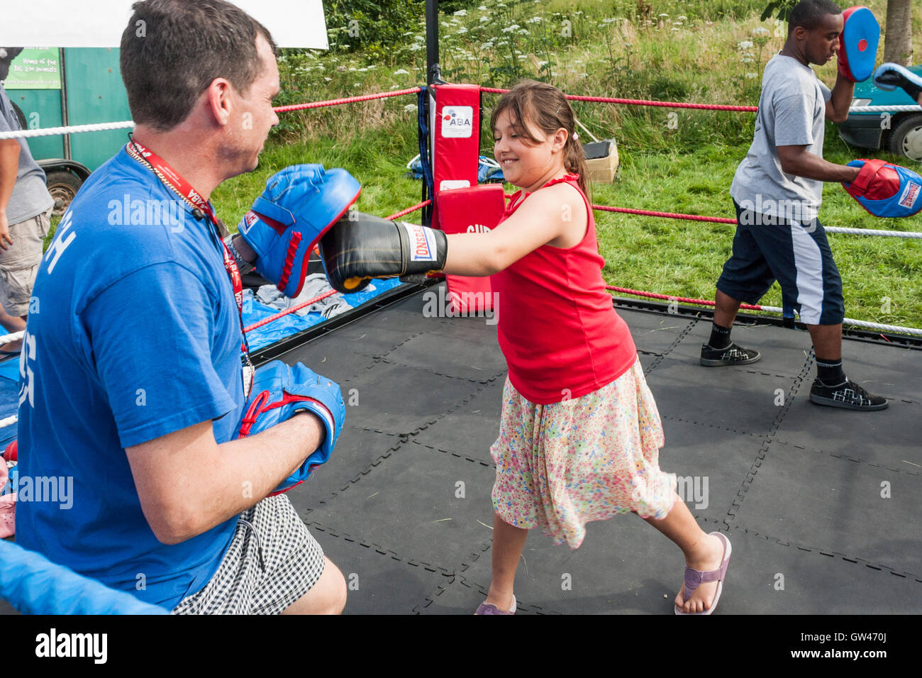 Boxing trainer teaching children to box Stock Photo Alamy