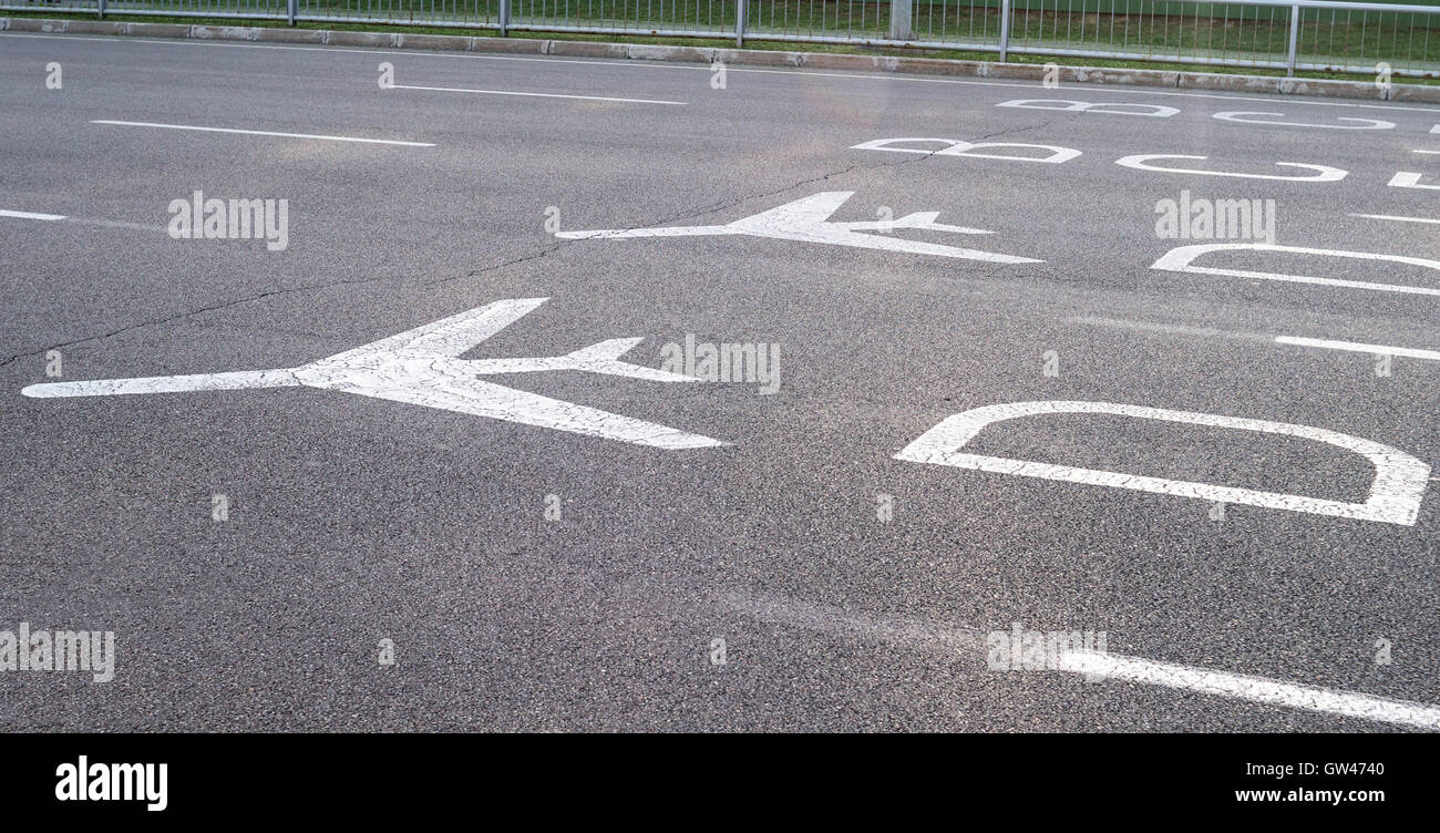 Airport directional signs on the road. White colored airplane signs and ...