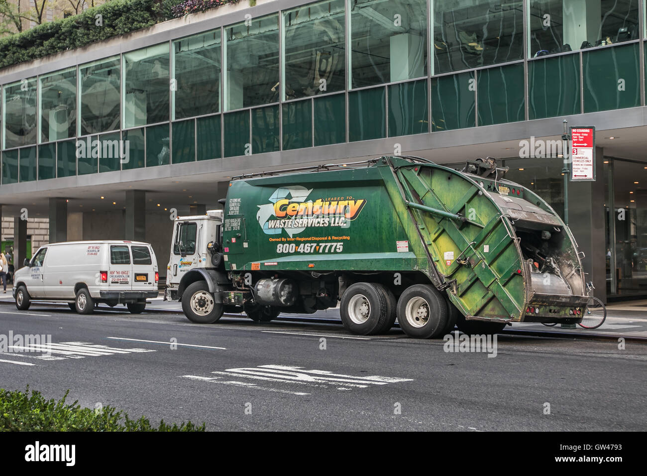 A green garbage truck on Park Avenue in New York City Stock Photo Alamy
