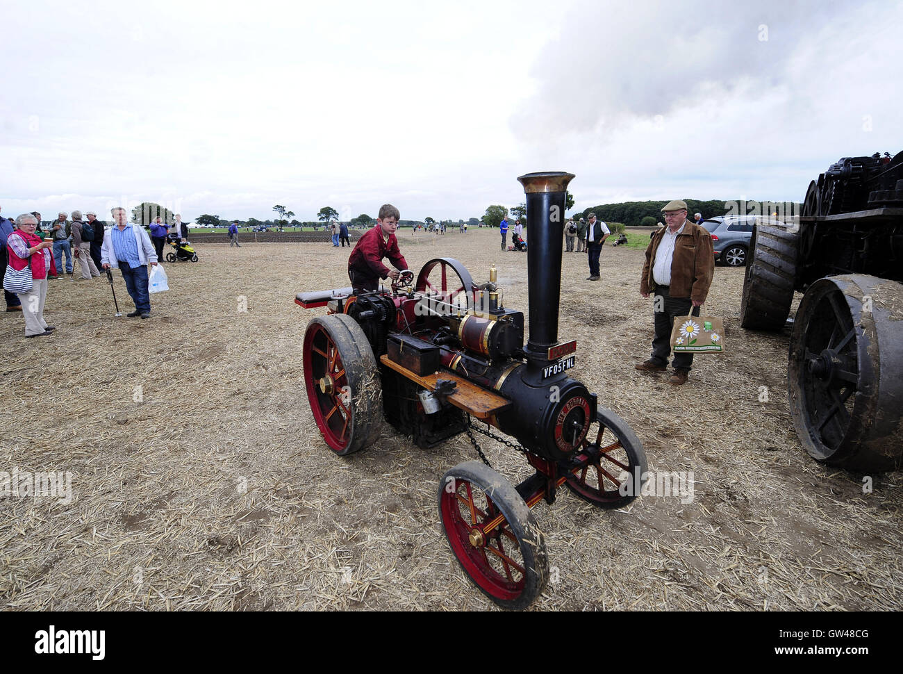Seven-year-old Tom Debes on this 6HP Burrell at the World Ploughing Contest at Crockey Hill near York, where representatives from over thirty countries competed in various categories that included vintage and horse drawn alongside conventional tractors. Stock Photo