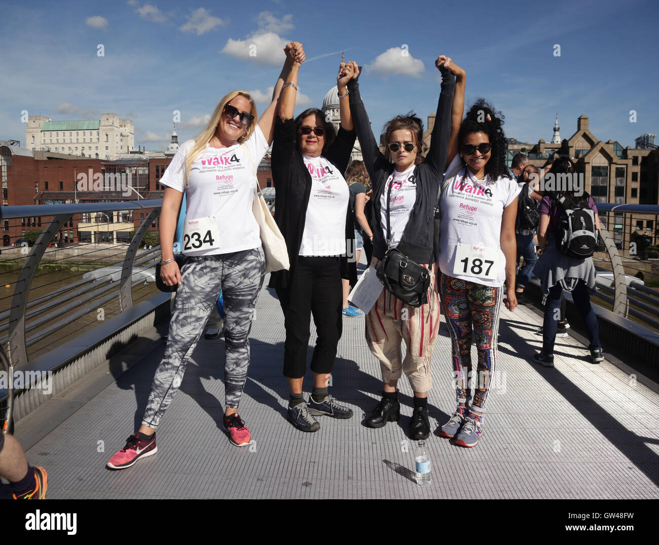 (From the left) Sam Nieman, Sandra Horley, chief executive of Refuge, Helena Bonham Carter and Natasha Cottriall pause for a photograph whilst walking across Millennium Bridge, London, during Refuge's 10km walk to raise funds for the domestic violence charity. Stock Photo