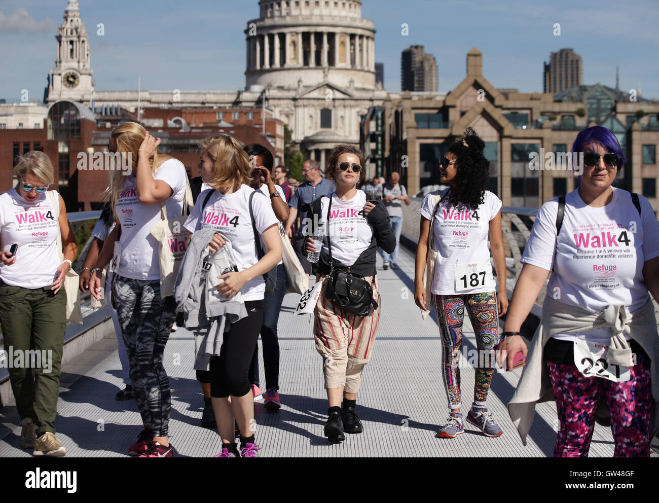 Helena Bonham Carter (centre) joins survivors and supporters walking across Millennium Bridge, London, during Refuge's 10km walk to raise funds for the domestic violence charity. Stock Photo