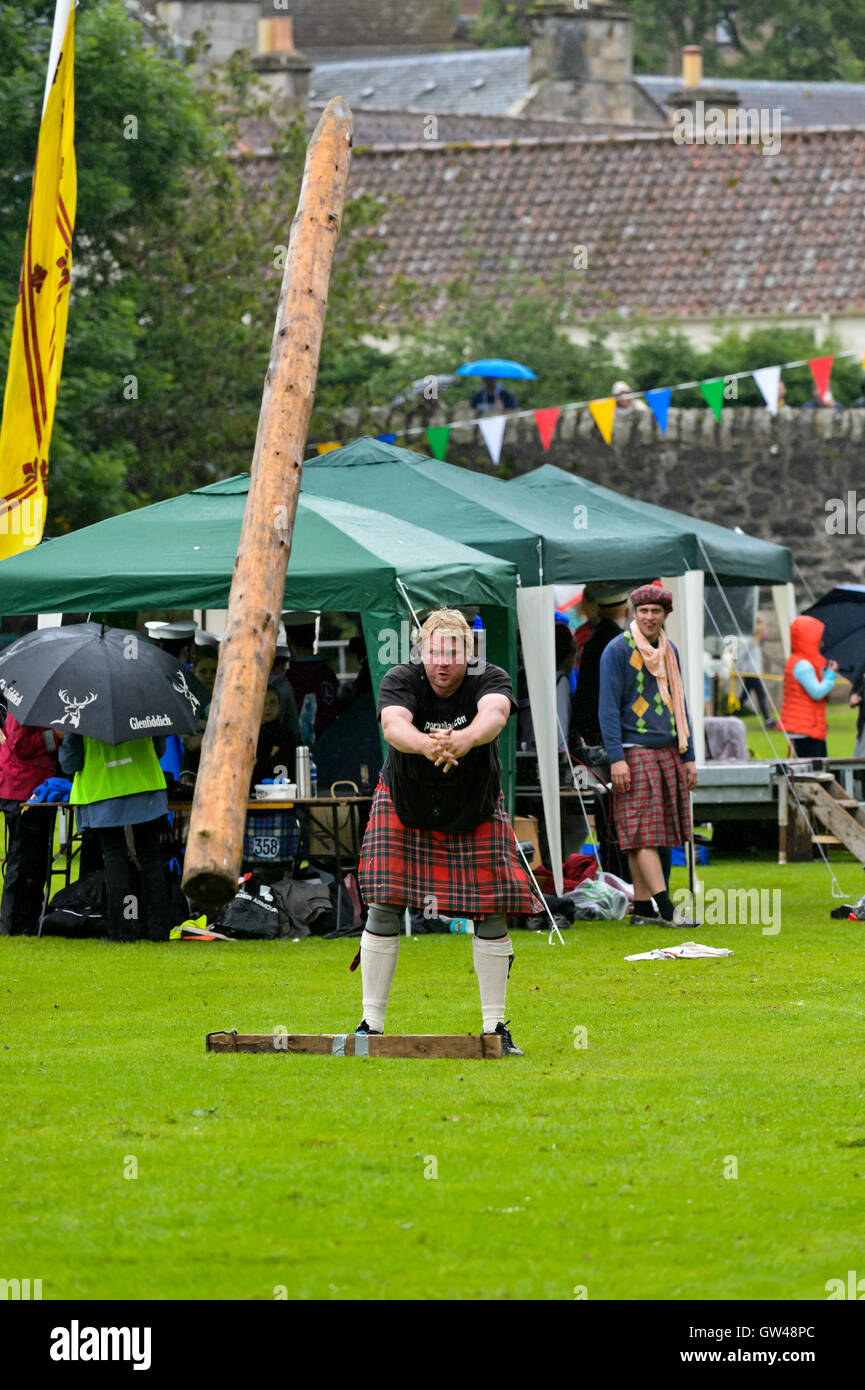 Participant in the caber tossing competition, Ceres Highland Games, Ceres, Scotland, United Kingdom Stock Photo