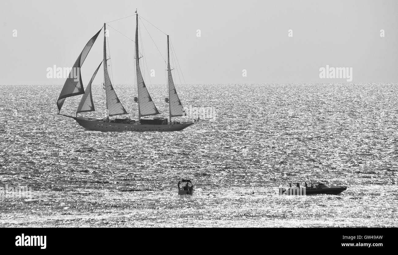 Three masted sailing boat in full sail on calm sea Stock Photo - Alamy