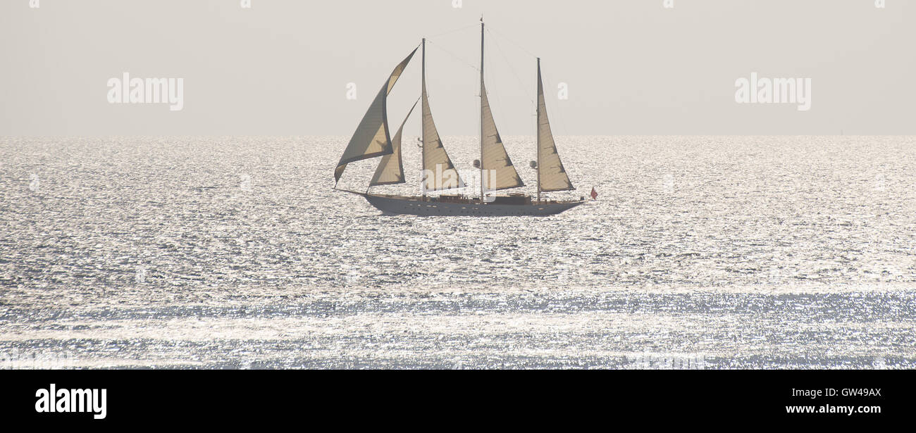 Three masted sailing boat in full sail on calm sea Stock Photo - Alamy