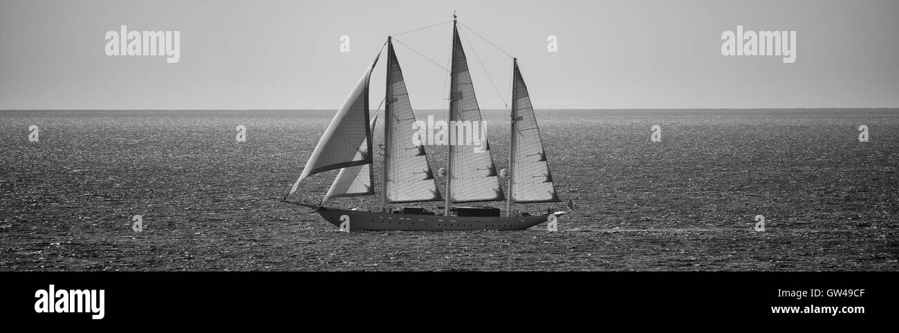 Three masted sailing boat in full sail on calm sea Stock Photo - Alamy