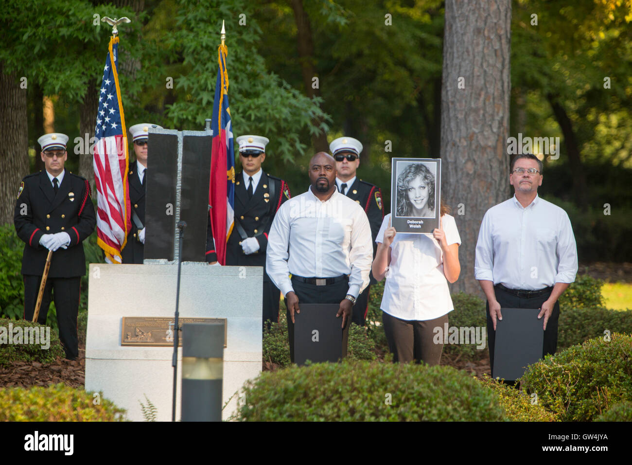 Arlington, Virginia, USA. 11th September, 2016. Members of the Onslow Civic Affairs Committee hold photos of those killed in the 9/11 terror attacks during a remembrance ceremony commemorating the 15th anniversary at the Lejeune Memorial Gardens September 11, 2016 in Jacksonville, N.C. Credit:  Planetpix/Alamy Live News Stock Photo