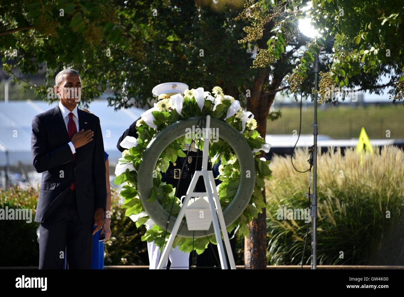 Arlington, Virginia, USA. 11th September, 2016. U.S President Barack Obama salutes after placing a wreath at the memorial during a ceremony commemorating the 15th anniversary of the 9/11 terrorist attacks at the Pentagon September 11, 2016 in Arlington, Virginia. Credit:  Planetpix/Alamy Live News Stock Photo