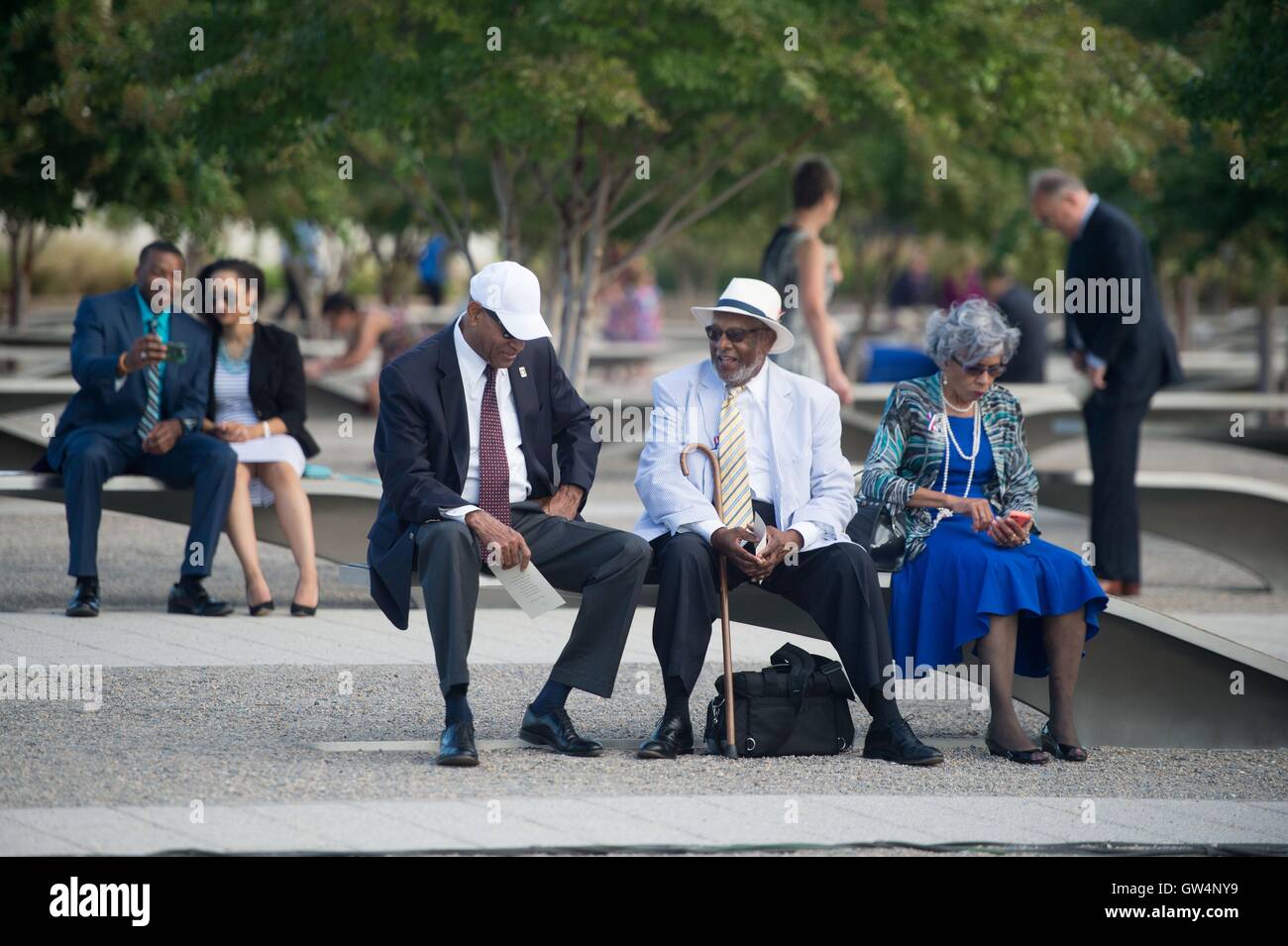 Family members who lost loved ones in the terror attacks at the Pentagon visit the memorial at a remembrance ceremony commemorating the 15th anniversary of the 9/11 terrorist attacks at the Pentagon September 11, 2016 in Arlington, Virginia. Stock Photo