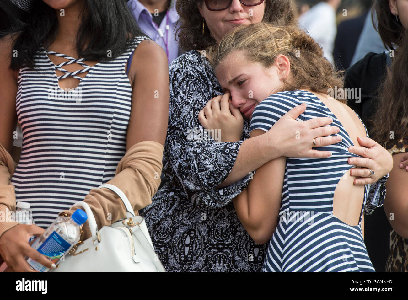Rachael Fisher, 12, reacts during a remembrance ceremony commemorating the 15th anniversary of the 9/11 terrorist attacks at the Pentagon September 11, 2016 in Arlington, Virginia. Fishers grandfather, Gerald Fisher, died during the attacks on the Pentagon. Stock Photo