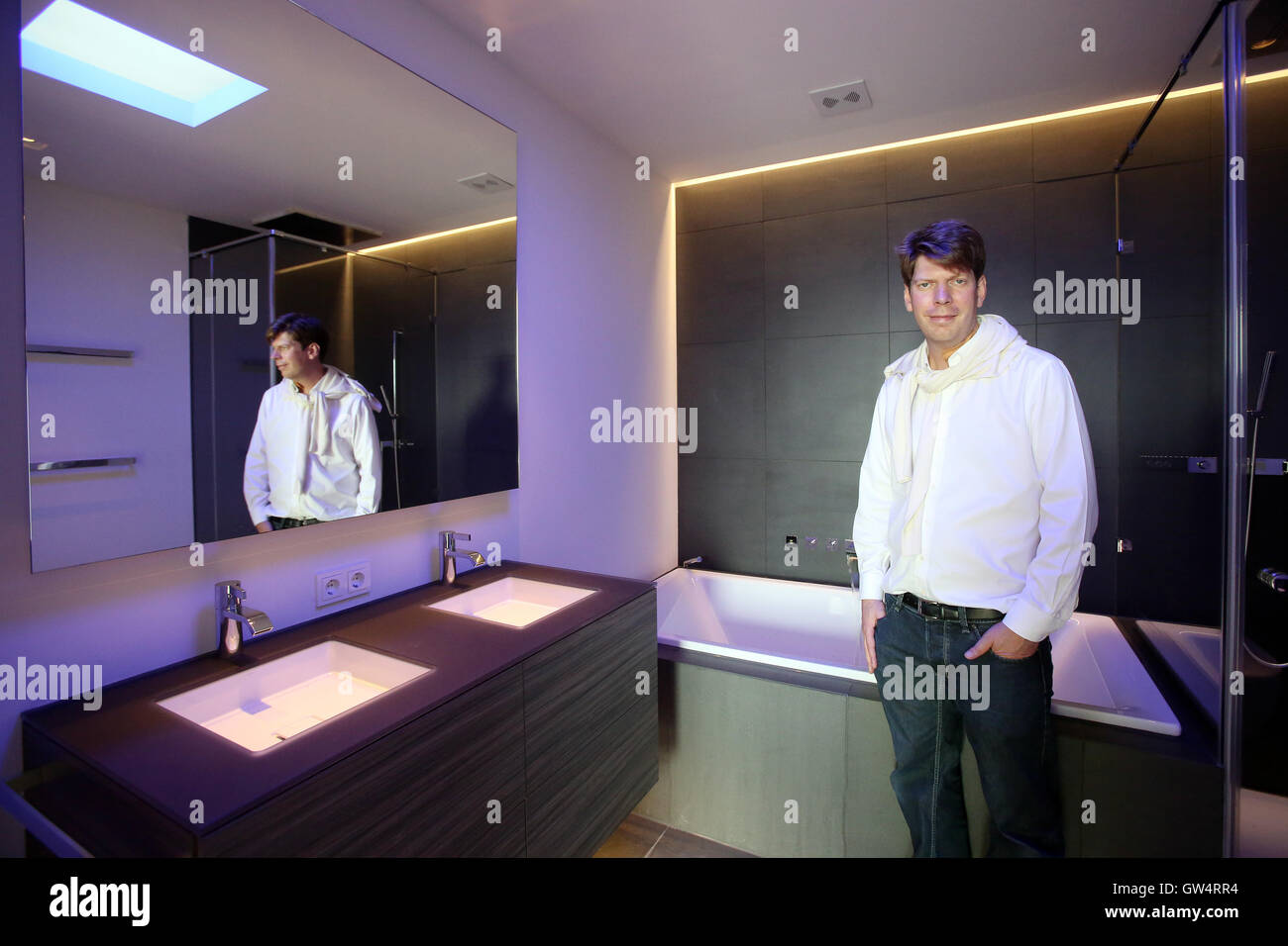 Hamburg, Germany. 01st Aug, 2016. Xing founder and building contractor of the 'Apartimentum, ' Lars Hinrichs, stands in the bathroom of 260-square-meter apartment where the bathwater can be drawn via tablet in the 'Apartimentum' in Hamburg, Germany, 01 August 2016. The 'Apartimentum' is a networked house in the district of Rotherbaum where multiple functionalities, like entries or room temperature, can be controlled via smartphone of tablet - also from a distance. Photo: BODO MARKS/dpa/Alamy Live News Stock Photo