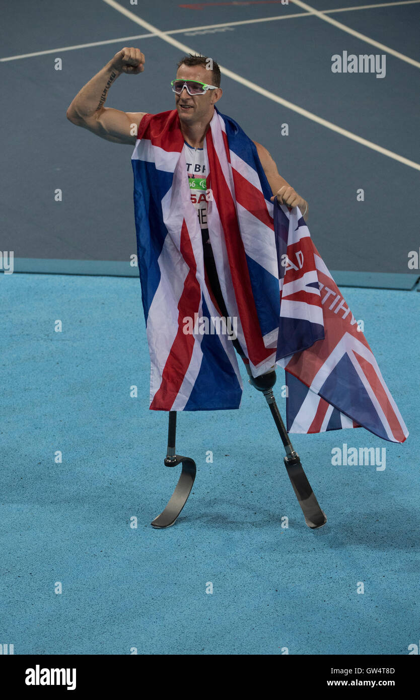 Great Britain's Richard Whitehead, dons Union Jack flag after winning the men's 200-meter T42 race at the Rio 2016 Paralympics. Stock Photo