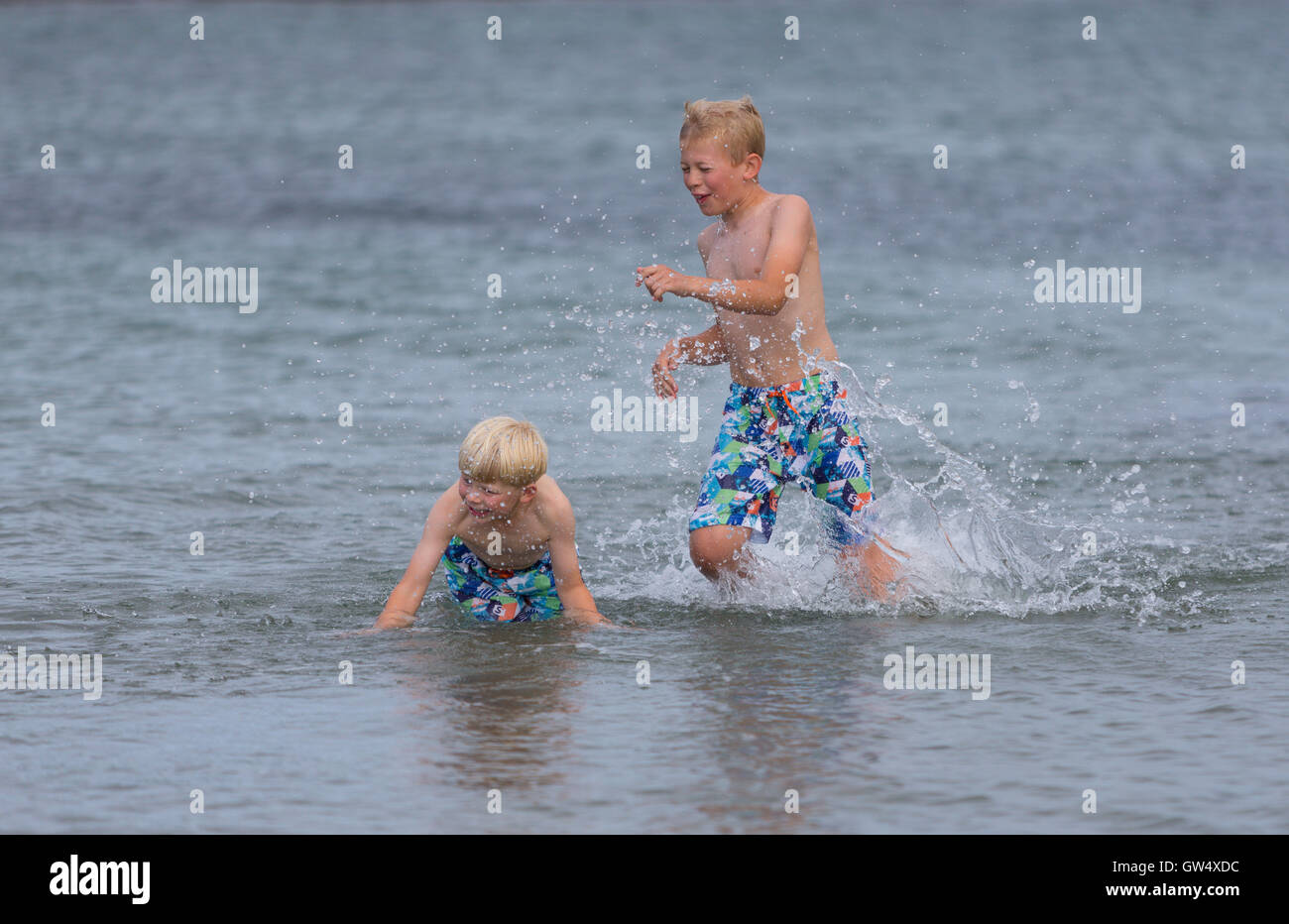 Young boys playing in the water Stock Photo