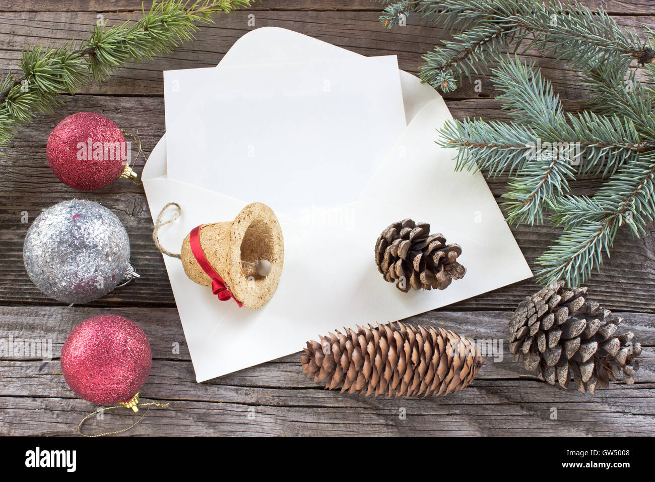 Pine cones, needles and Christmas balls on wooden background Stock Photo