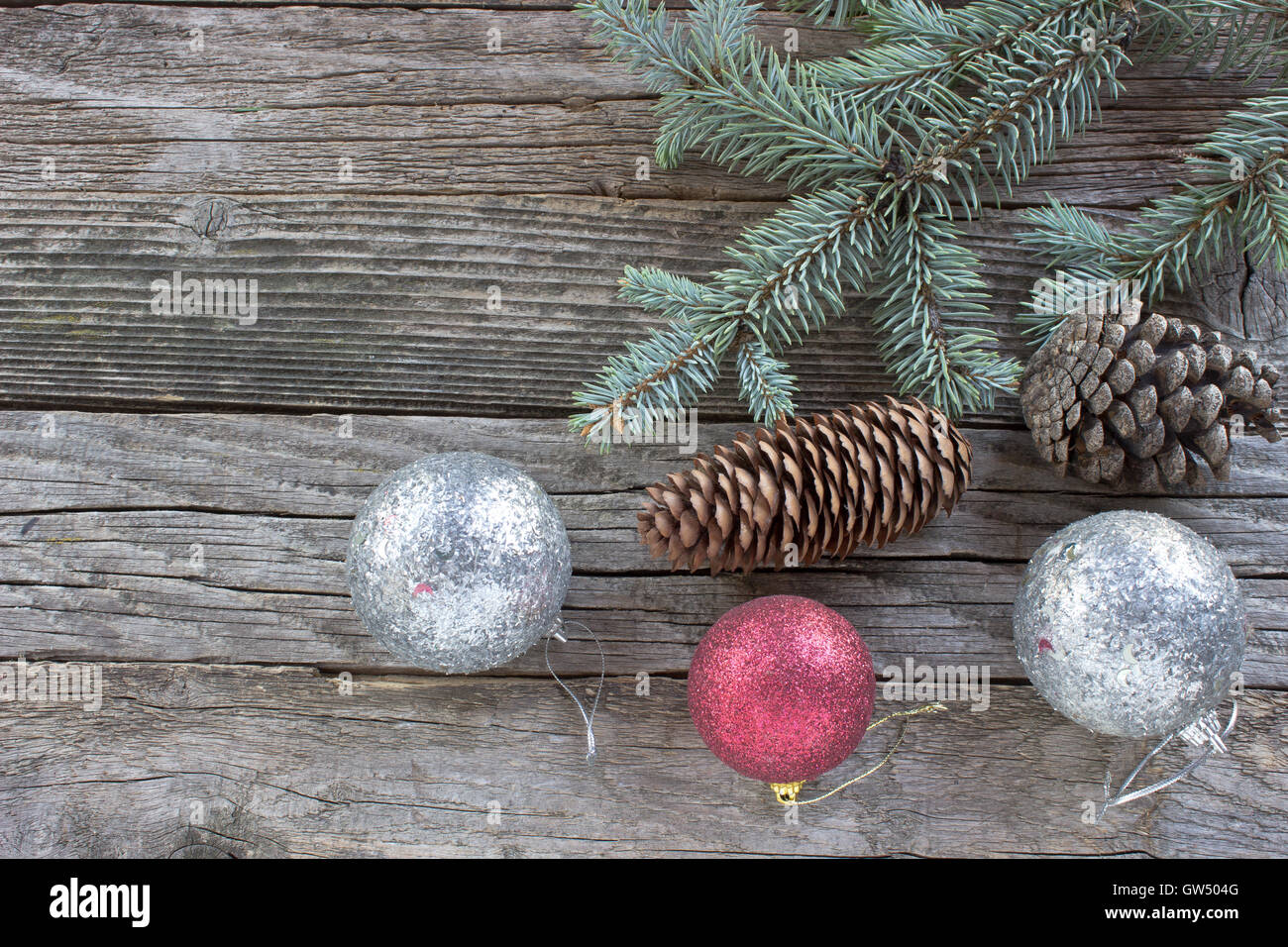 Christmas balls,  pine cones and  needles  on wooden background Stock Photo