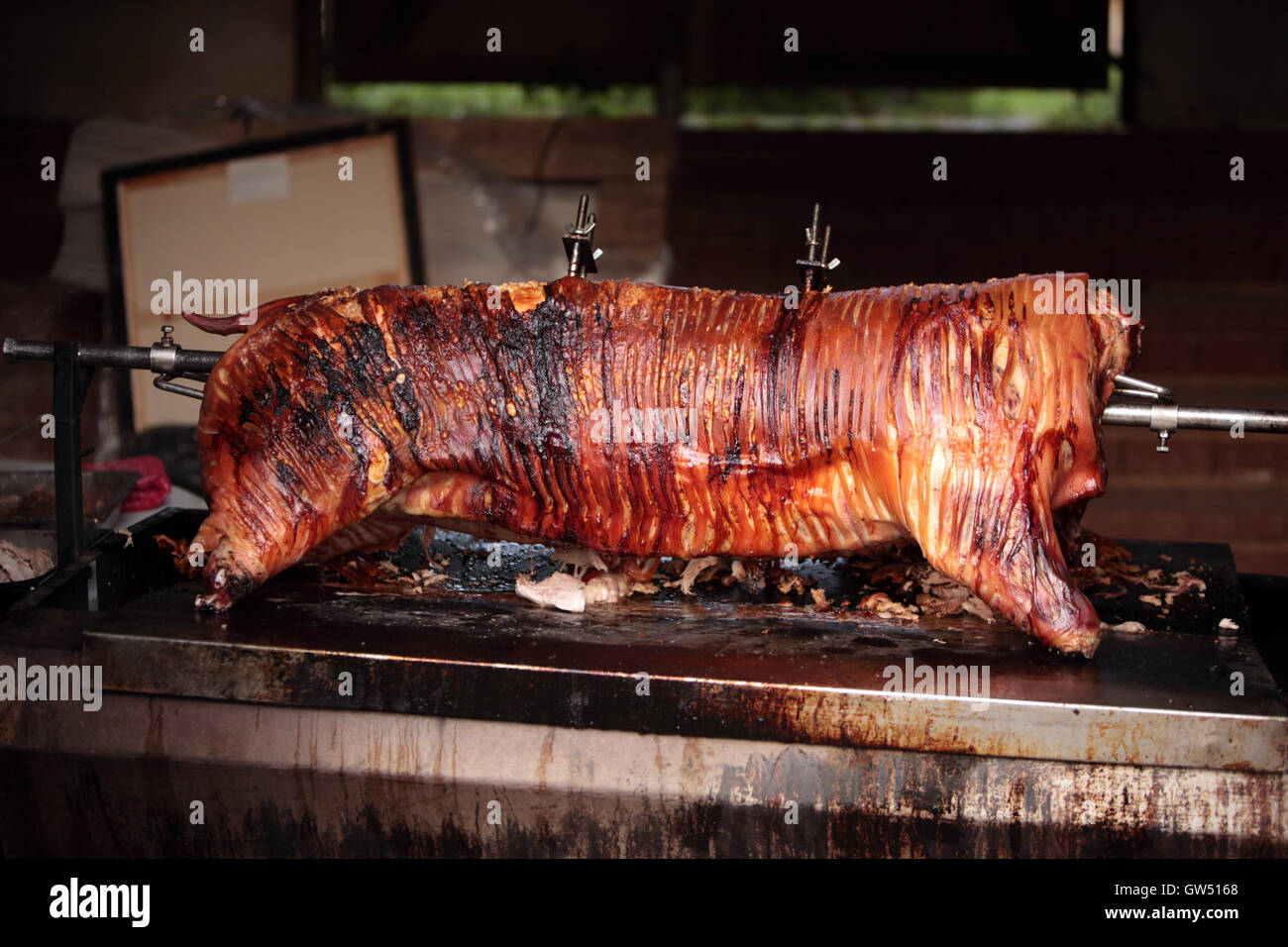 A hog roast on a rotisserie almost ready for carving Stock Photo