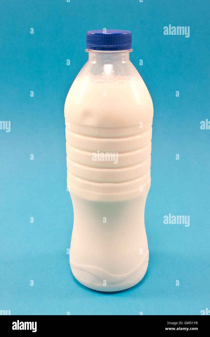 Bottle of milk isolated on blue background Stock Photo