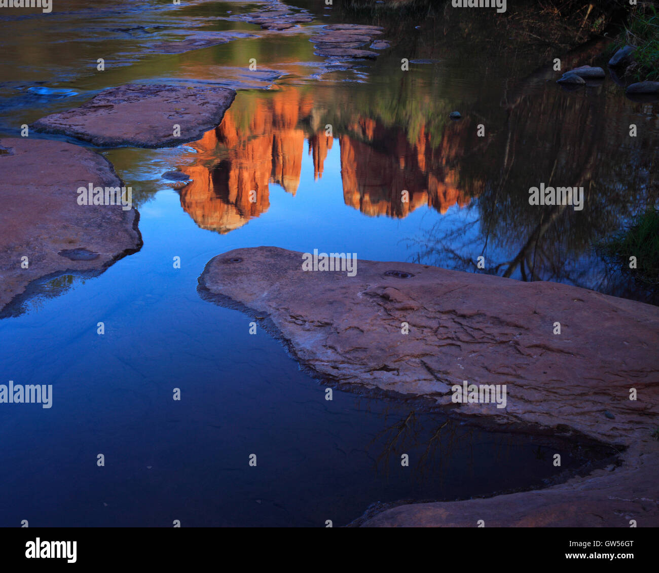Cathedral Rock at sunset reflected in the still waters of Oak Creek in