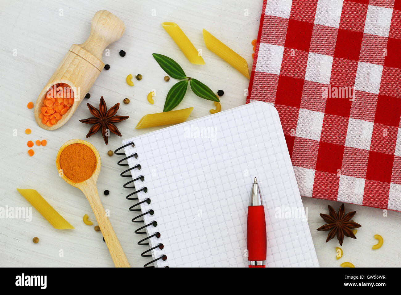 Empty notebook with pen and different ingredients spread around it Stock Photo