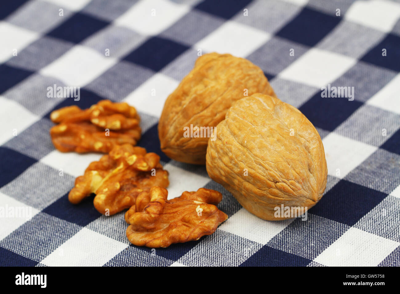 Walnuts with and without shell on checkered cloth, closeup Stock Photo ...