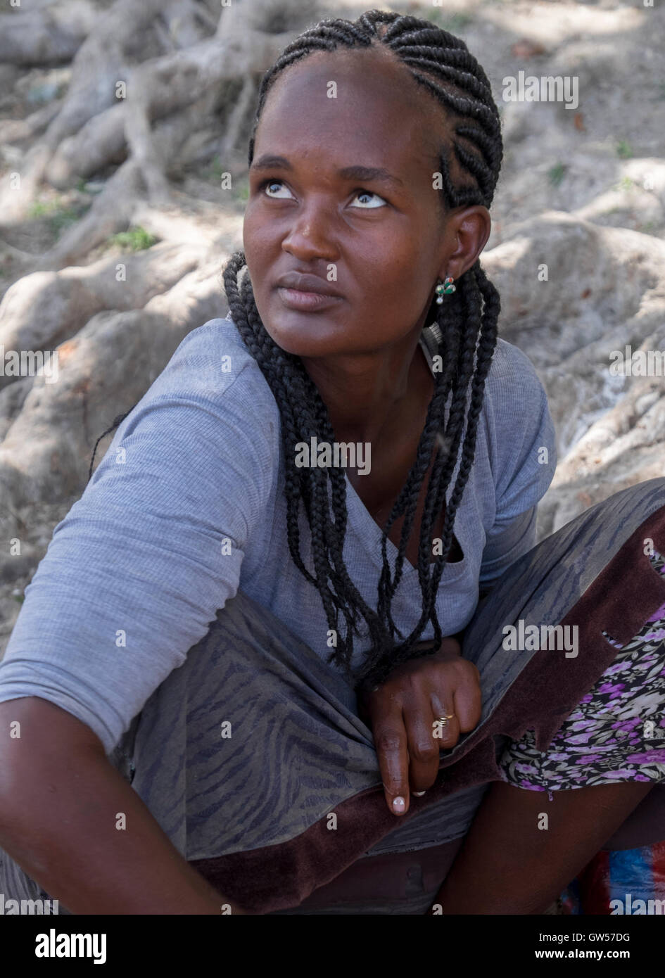 Beautiful young Ethiopian woman selling fish in a market in the Omo Valley Stock Photo