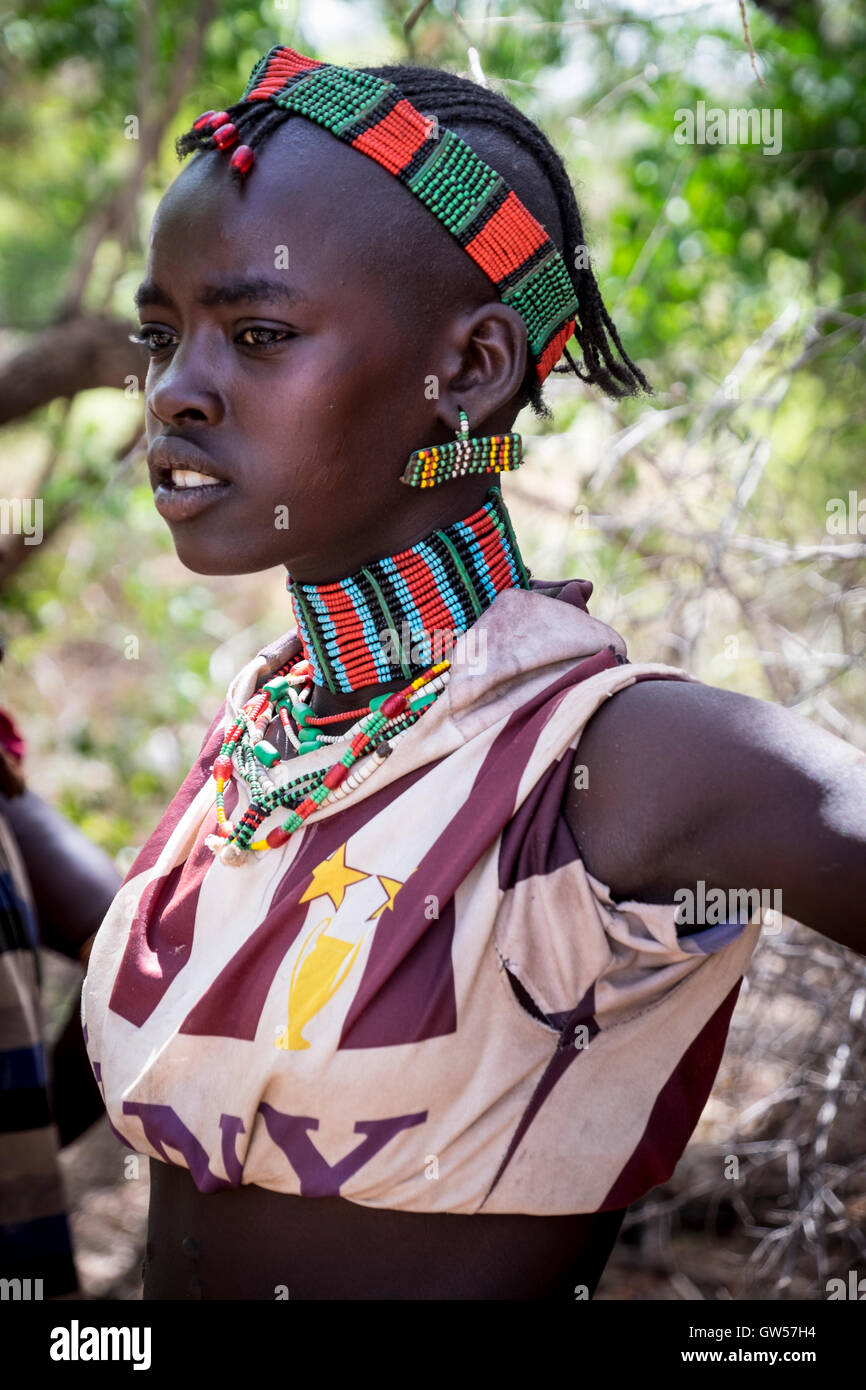 Portrait of a young woman of the Hammer tribe in traditional dress of