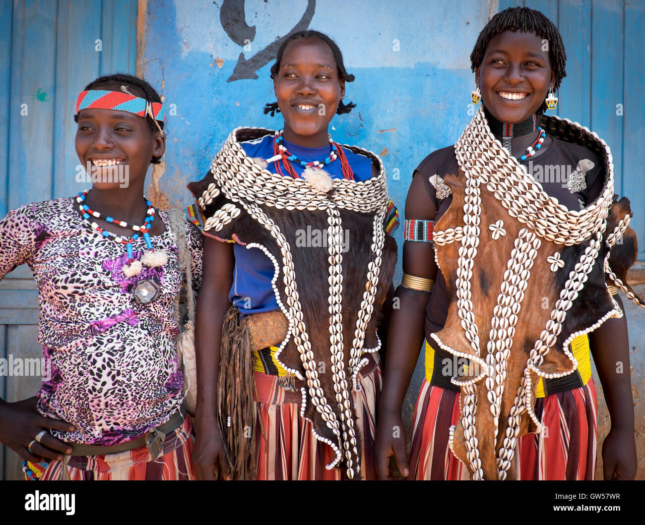 Three women at the Key Afer market in the Omo Valley of southern Ethiopia dressed in traditional cowrie shell ornaments and bead Stock Photo