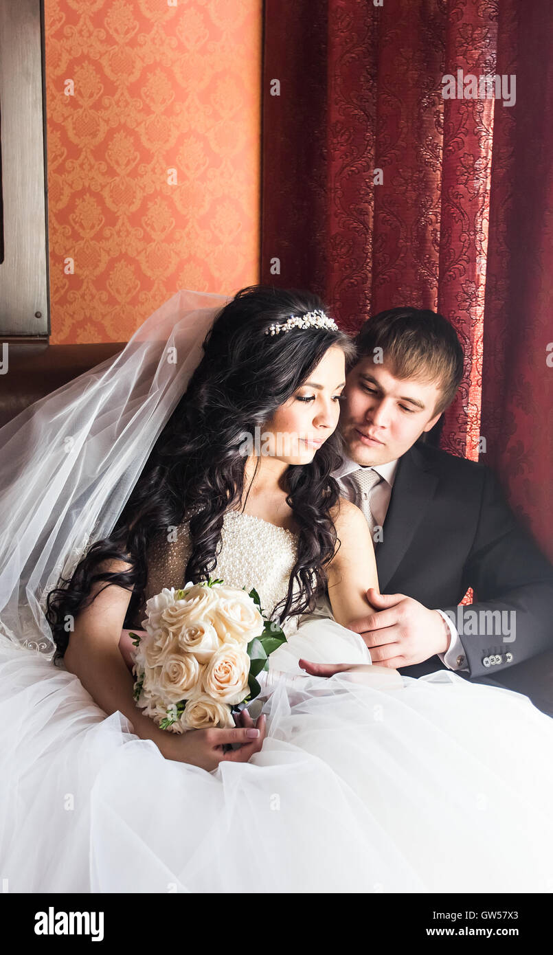 Wedding couple indoors is hugging each other Stock Photo - Alamy