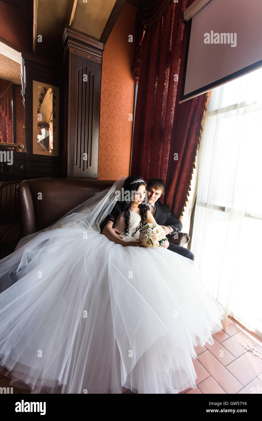 Wedding couple indoors is hugging each other Stock Photo - Alamy