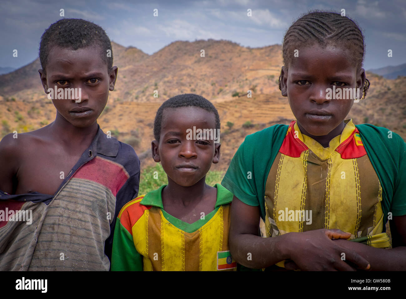 Three children of the Konso tribe in the mountainous area of Southern Ethiopia pause for a portrait. Stock Photo