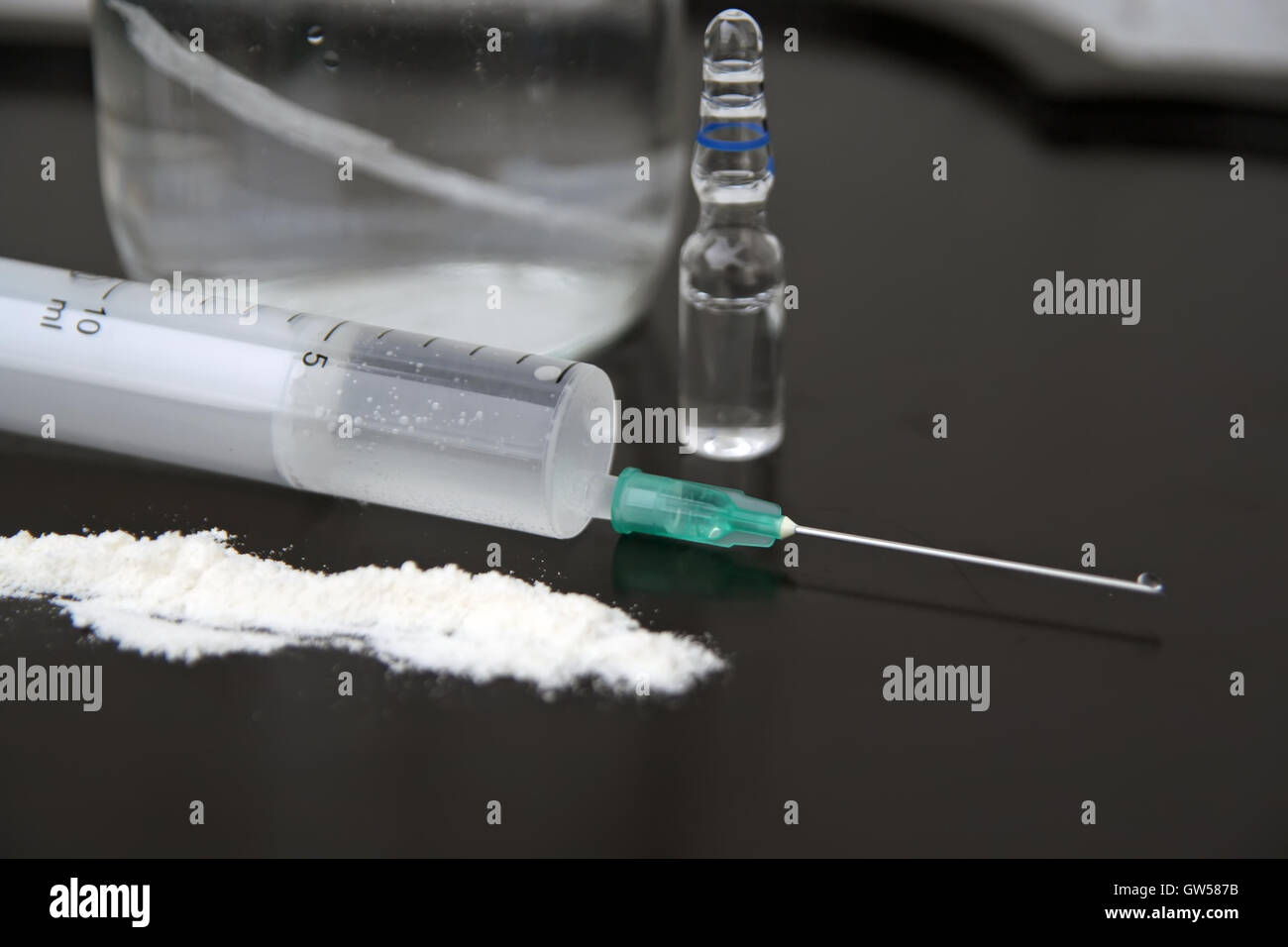 Medical syringe and narcotics. Intravenous application of drugs. Stock Photo