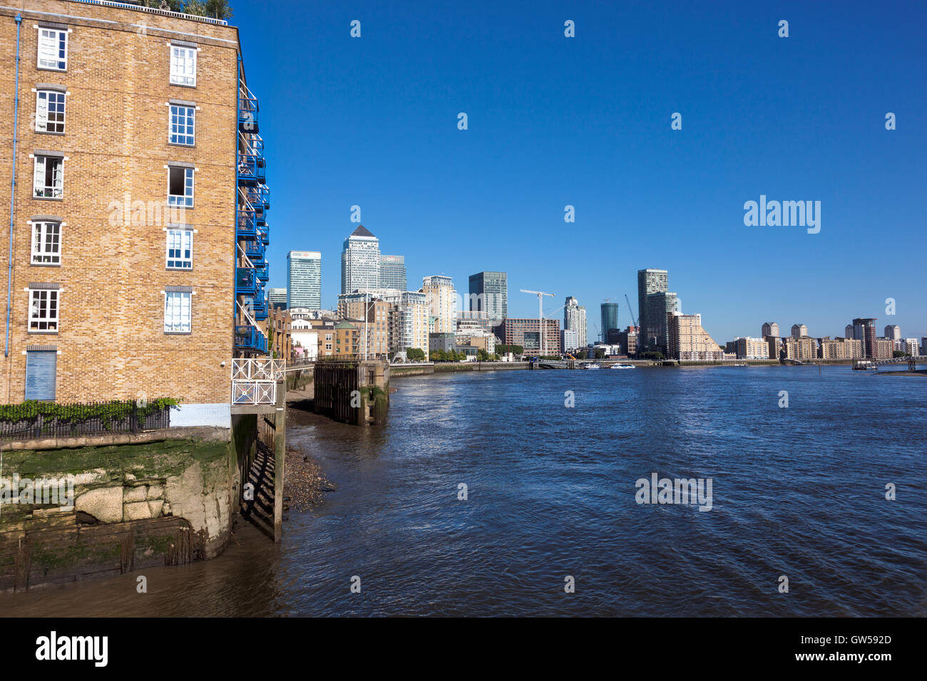 The skyscrapers of Canary Wharf viewed from the Thames bank in Limehouse, London, UK Stock Photo