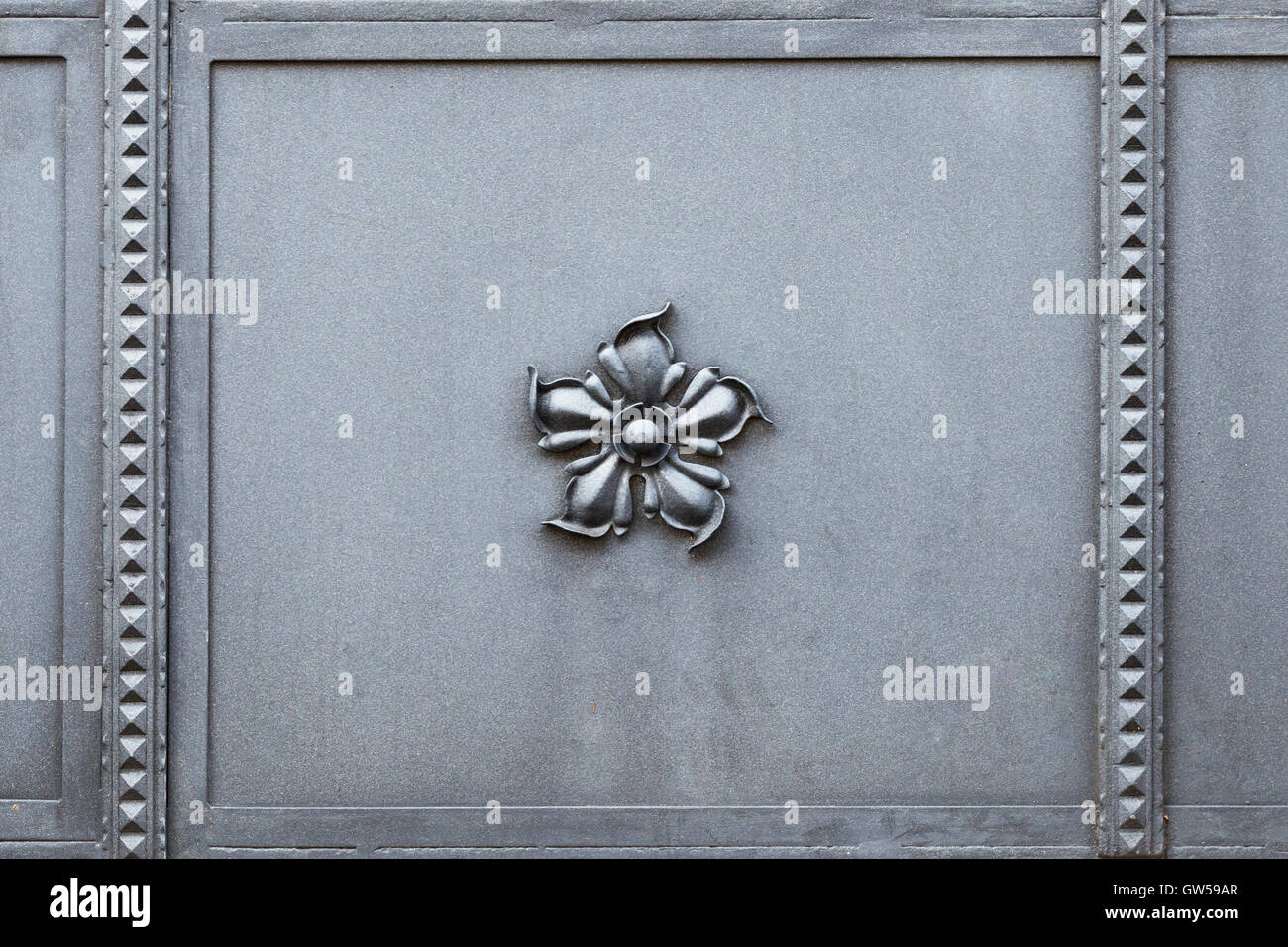 Beautifully crafted metal gate with an elegant flower in the middle Stock Photo