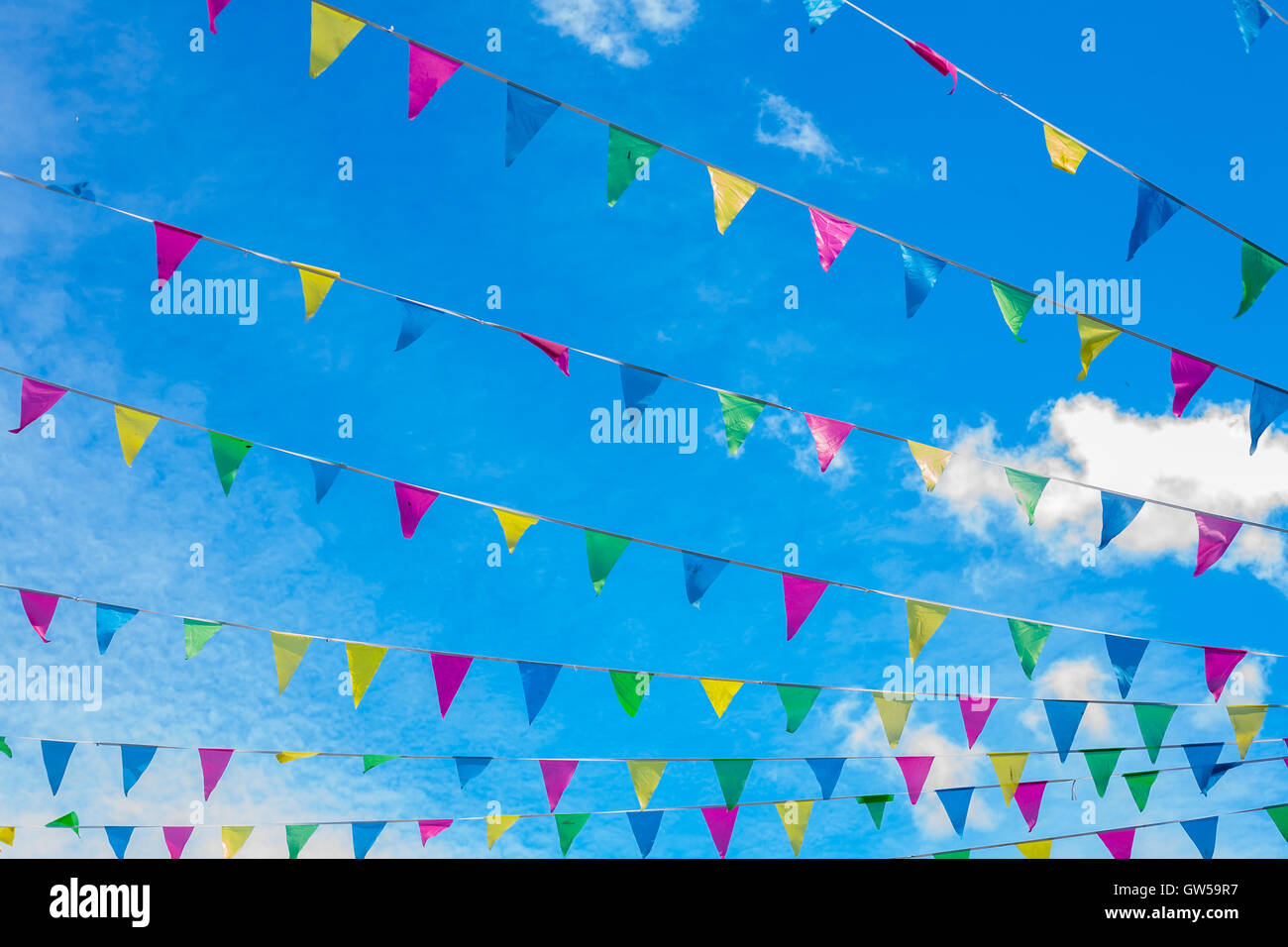Celebration colorful flag bunting with brilliant blue sky background Stock Photo