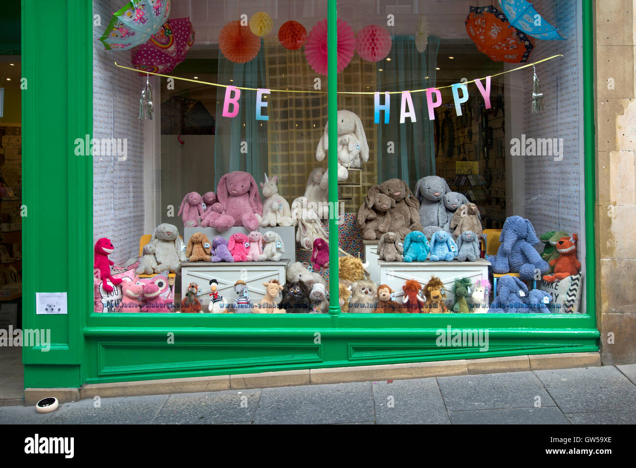 'Be Happy' sign in the window of a shop selling soft cuddly toy animals in Cockburn Street, Edinburgh, Scotland, UK Stock Photo