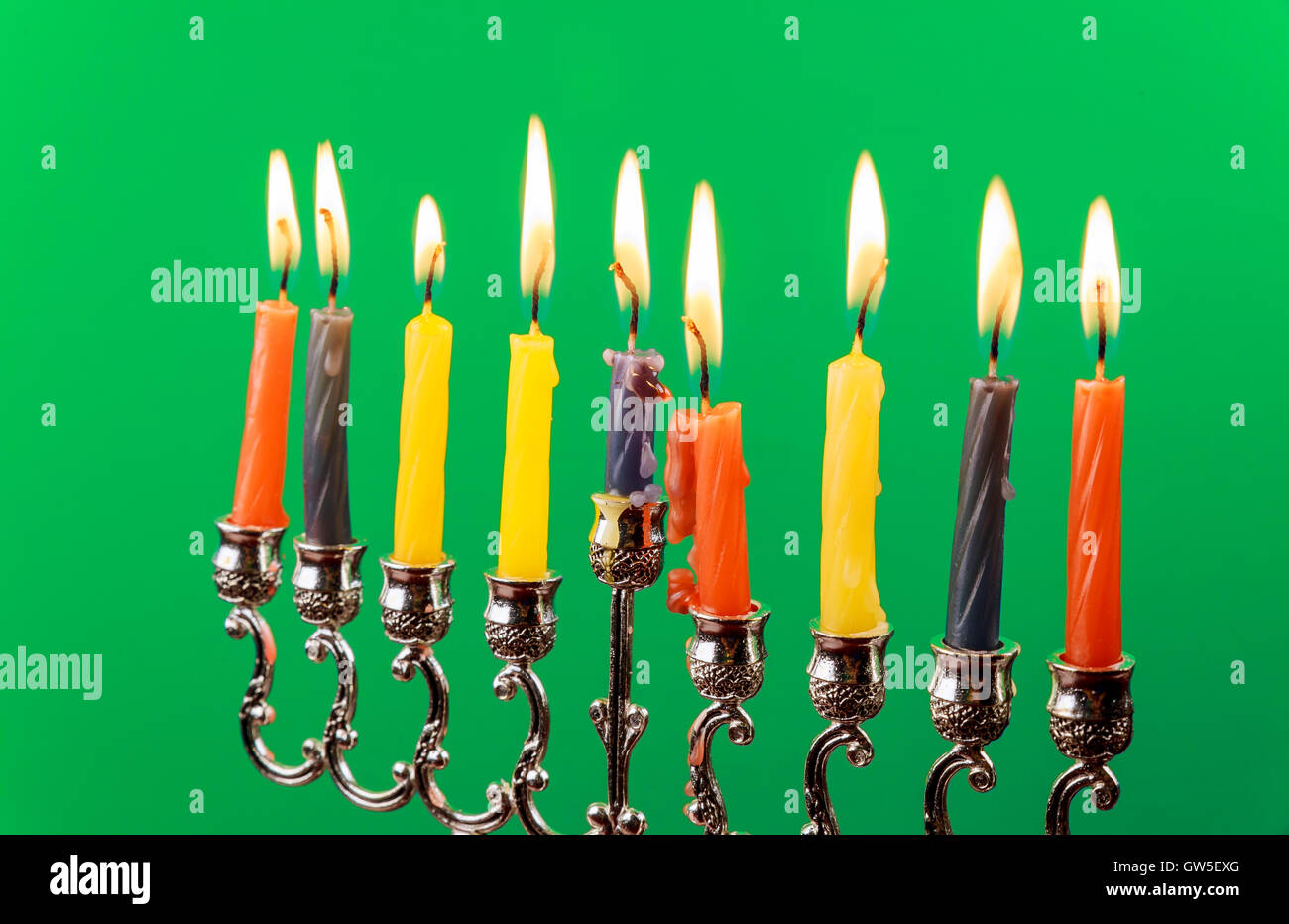 Hanukkah menorah with candles green background isolation Stock Photo