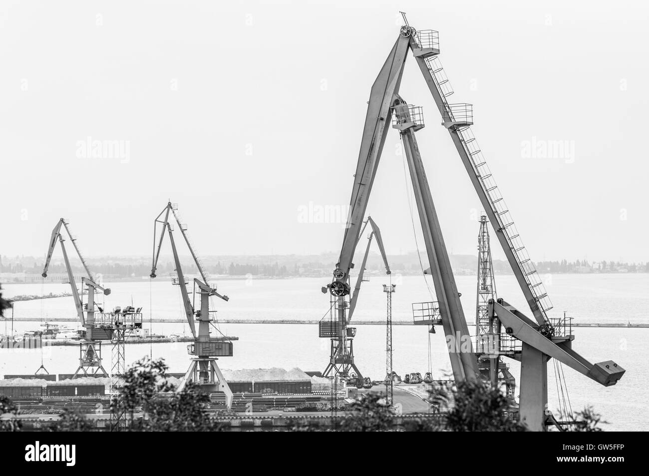 Dockyard cranes in Odessa Marine Trade Port. Black and White photo. Odessa, Ukraine - August 22, 2016. Stock Photo