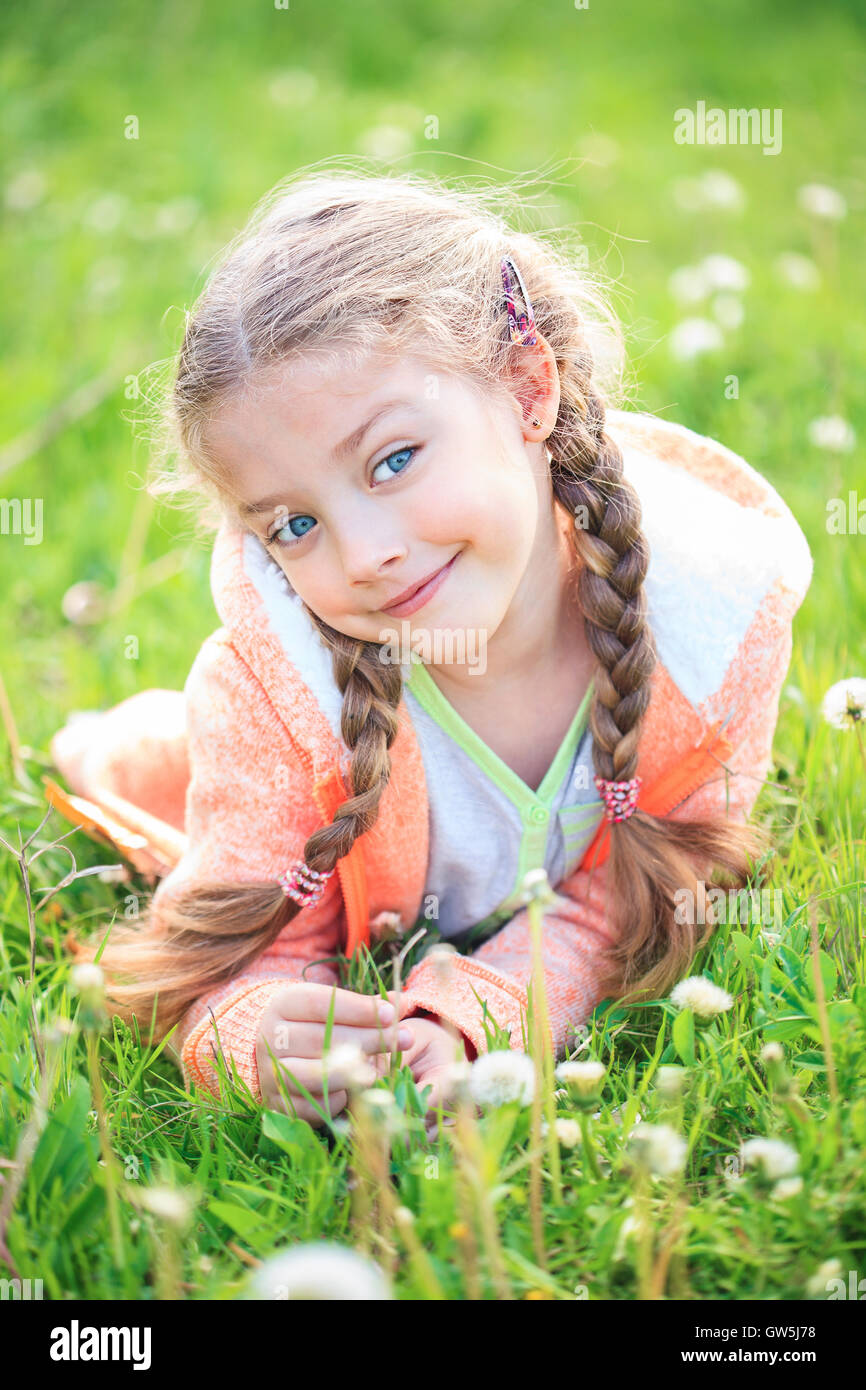 Cute little girl on the meadow in bright summer day Stock Photo - Alamy