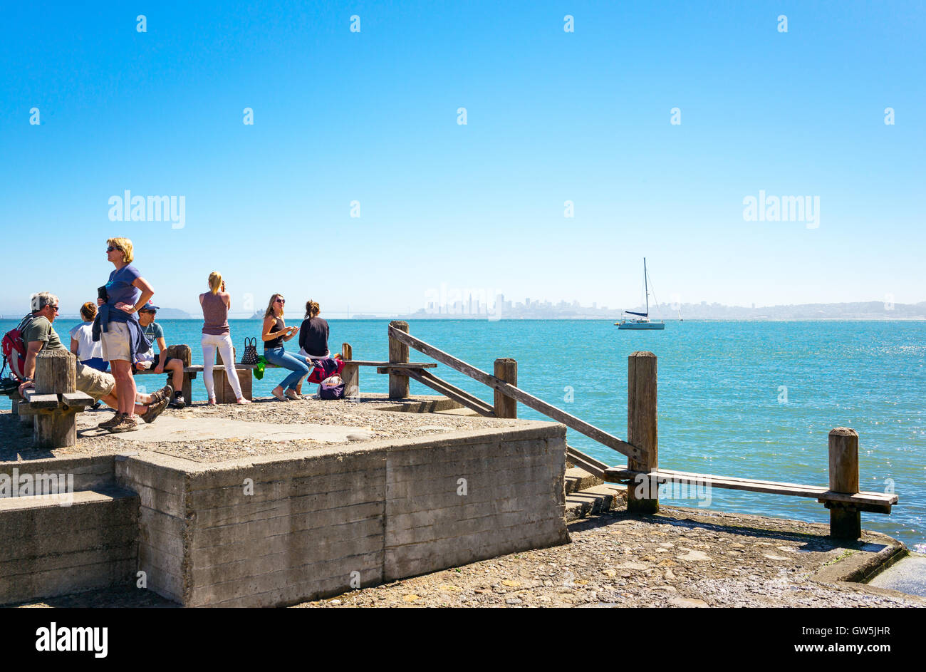 Sausalito, USA - September 23, 2015: Tourists on a pier looking at the bay with the San Francisco skyline in the background Stock Photo