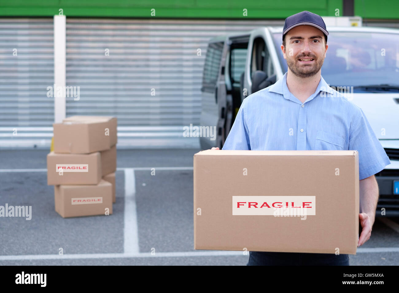 Portrait of confidence express courier next to his delivery van Stock Photo