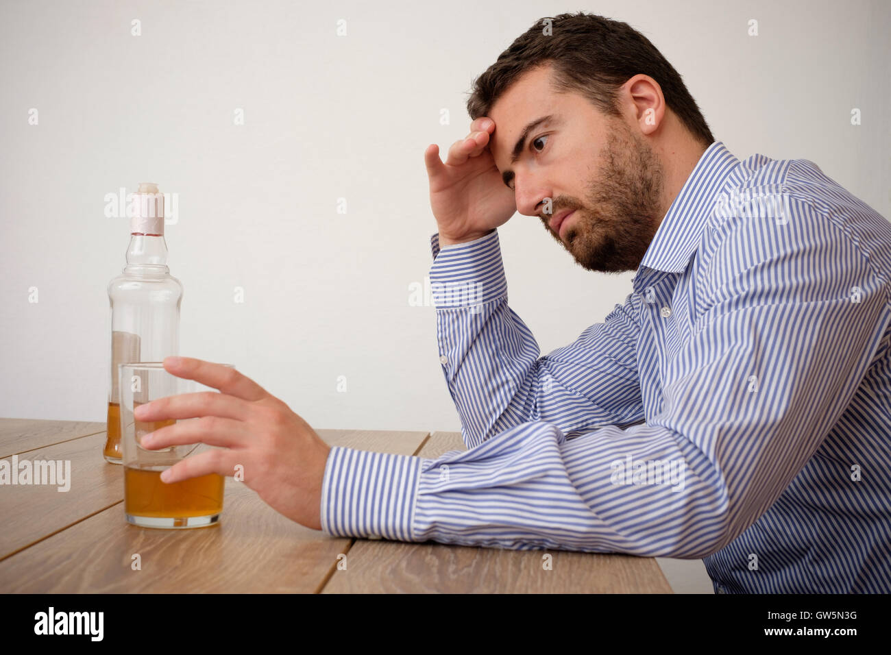 Man feeling bad because of alcohol abuse Stock Photo