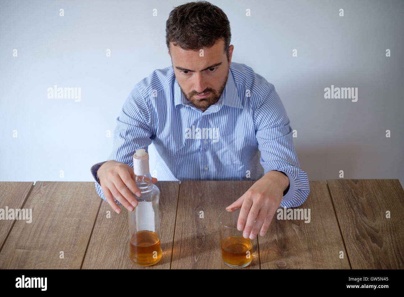 Man feeling bad because of alcohol abuse Stock Photo