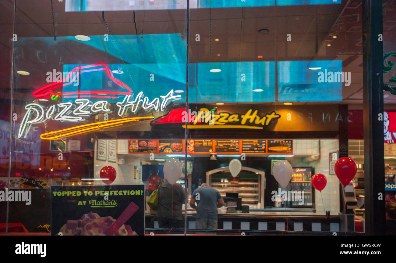 A Pizza Hut, located in a storefront with other Riese Restaurants