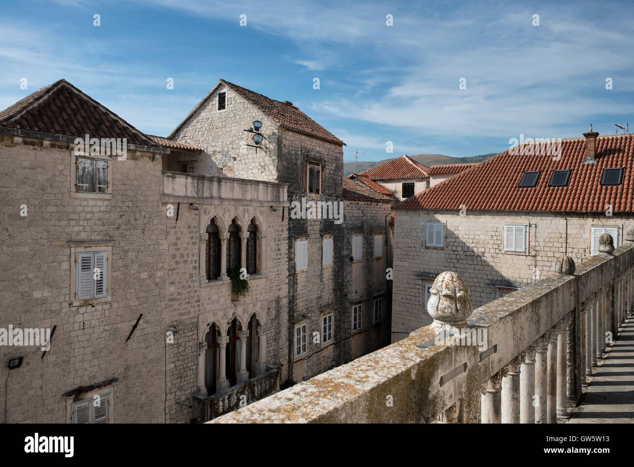 View on the facade of the Grand Cipiko Palace with its decorated Venetian Gothic three-light windows. Trogir, old town, Croatia. Stock Photo