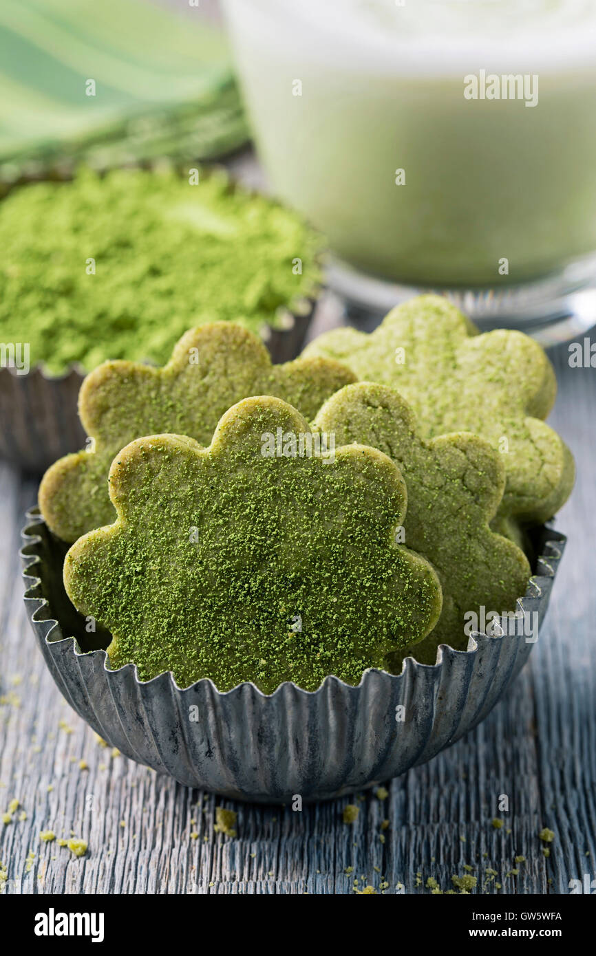 Matcha green tea latte and cookies on a wooden background Stock Photo