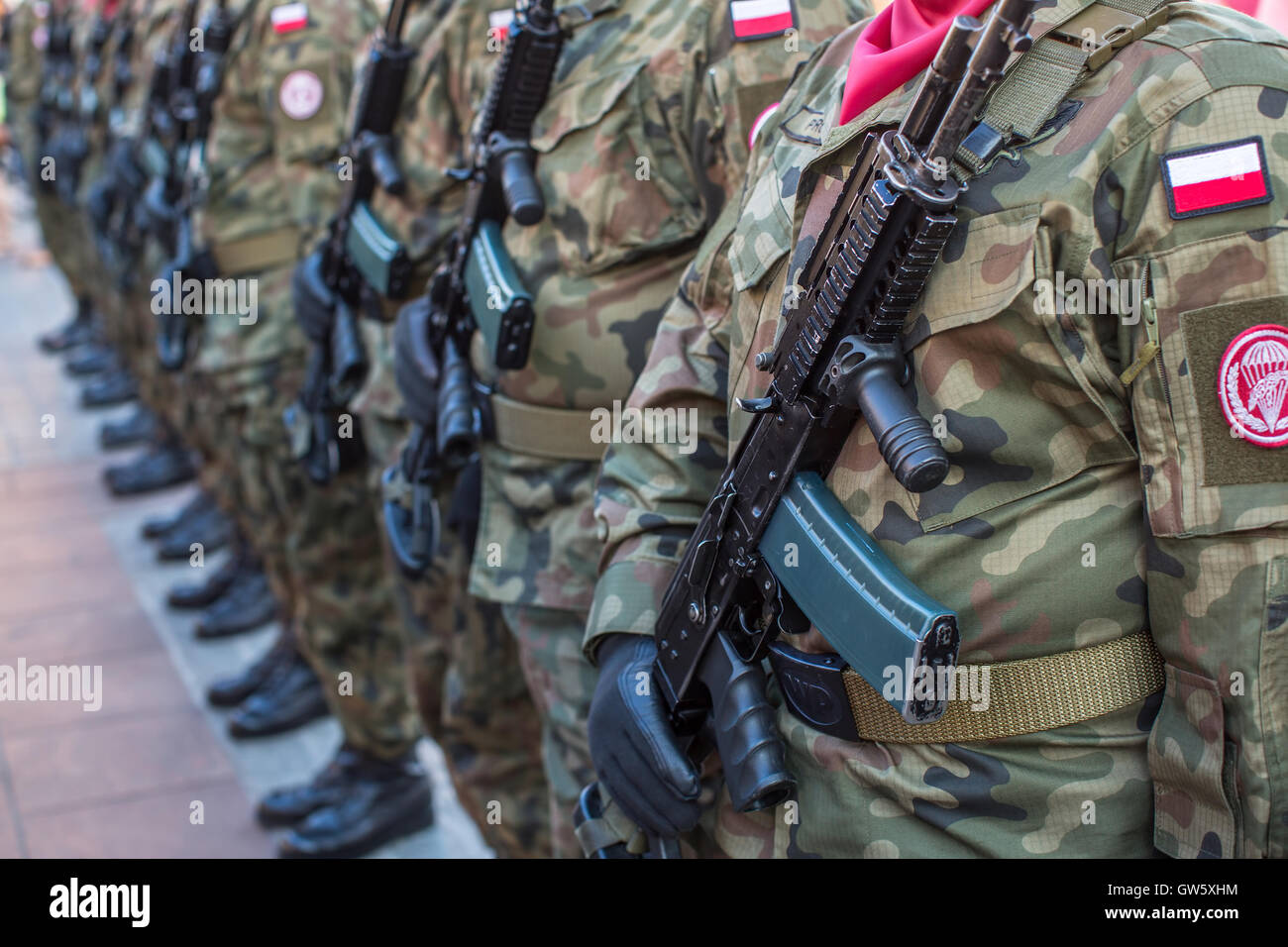 Polish soldiers in the ranks at uniforms with guns. Stock Photo