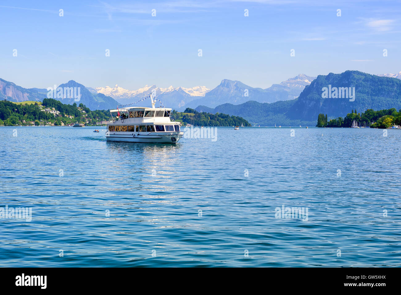 Cruise ship in front of snow covered Alps mountains peaks on Lake Lucerne, central Switzerland Stock Photo