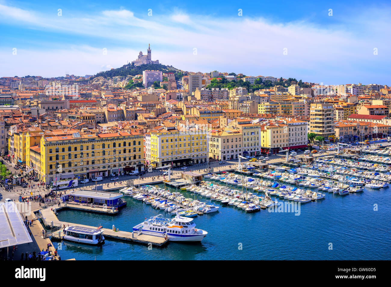 The old Vieux Port and Basilica Notre Dame de la Garde in the historical city center of Marseilles, France Stock Photo
